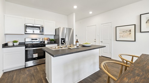 0995 Sarah Floorplan gourmet kitchen with stainless steel appliances gallery image – Wayside in Uhland TX