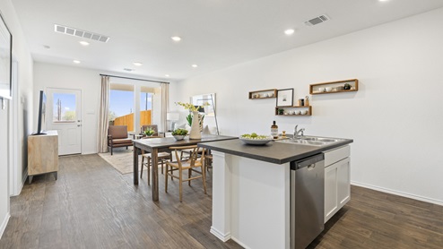 Beautiful modern kitchen with white cabinetry, stainless steel appliances and a large island