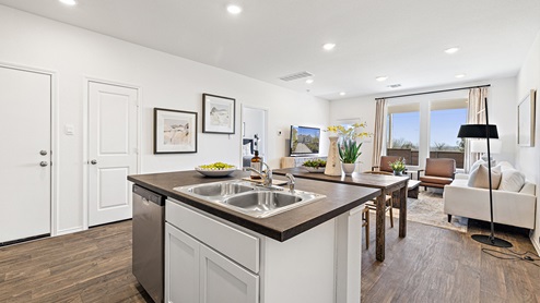 Beautiful modern kitchen with white cabinetry, stainless steel appliances and a large island