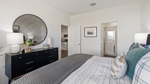 Bedroom decorated in modern decor featuring a bed with a black headboard and black dresser