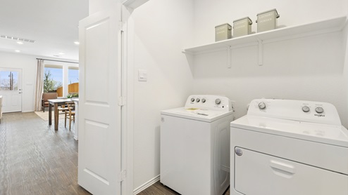 spacious laundry room with side by side washer and dryer