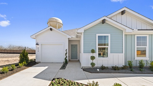 Front exterior view of a 1 story blue and white siding modern farmhouse