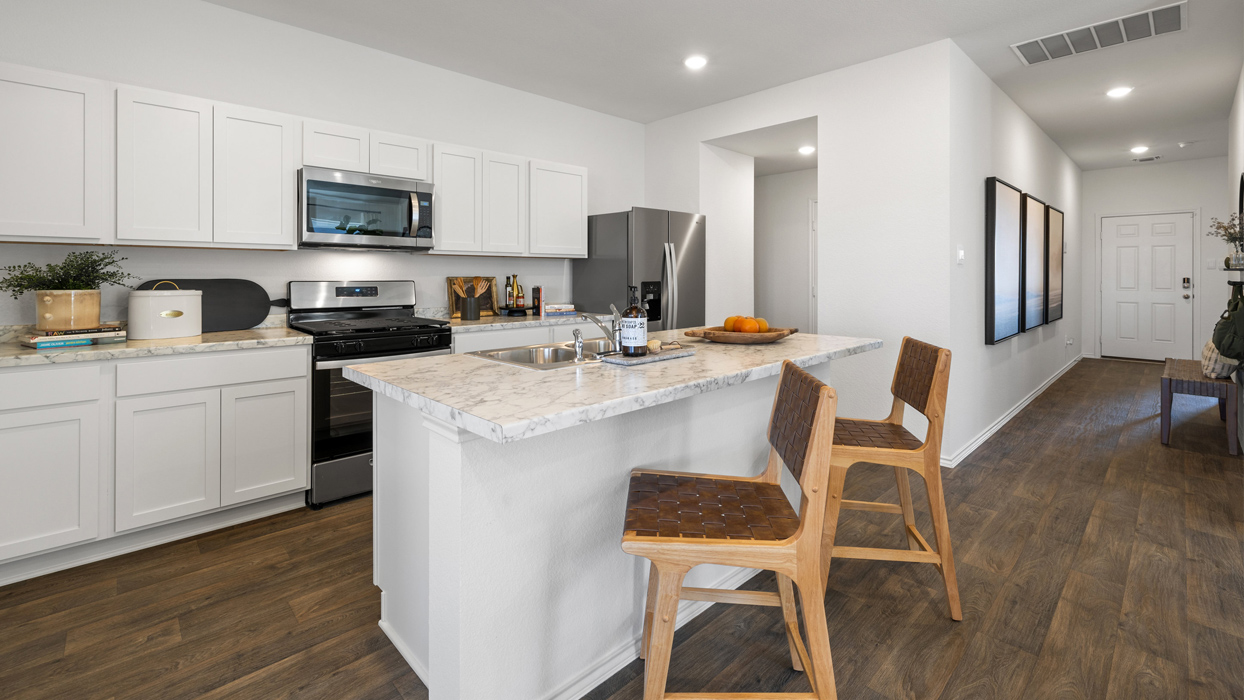 Interior kitchen with center island and white cabinets