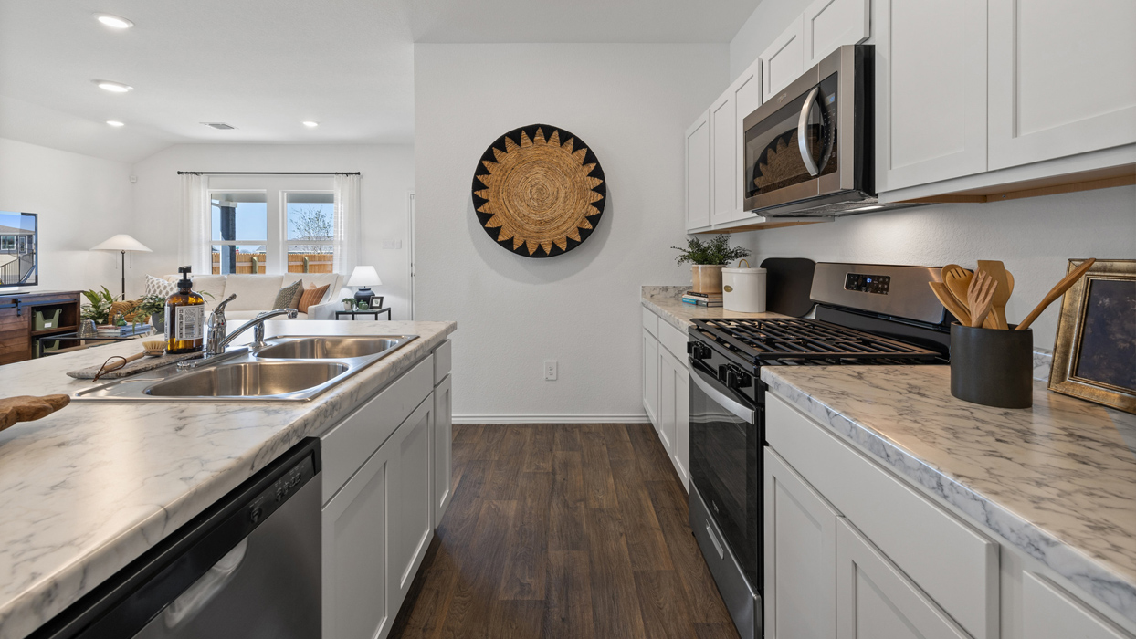 X35C The Caden Foorplan gourmet kitchen with stainless steel appliances