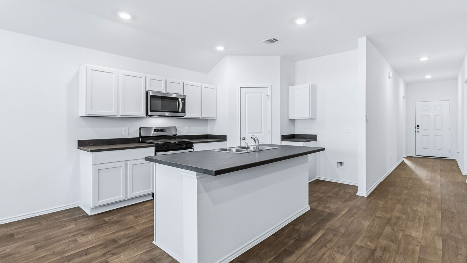 Central kitchen island with sink and seating, appliance suite included, prep zones and pantry access Wayside