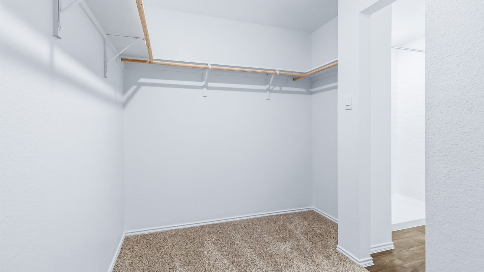Interior view of the walk-in closet connected to the primary bedroom with spa-inspired ensuite and generous storage