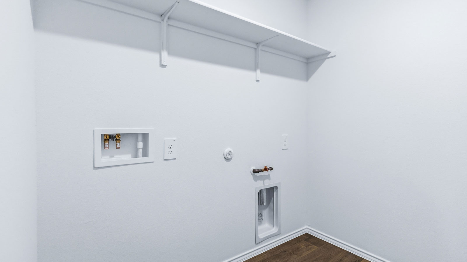 Laundry utility in Wayside’s new home by D.R. Horton with washer, dryer, storage options, and drop zone