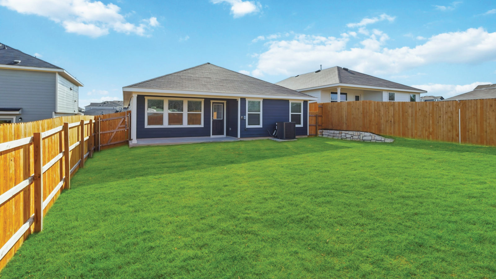 Backyard adds concrete patio for seating, grill setup, and smooth indoor-outdoor transition Wayside
