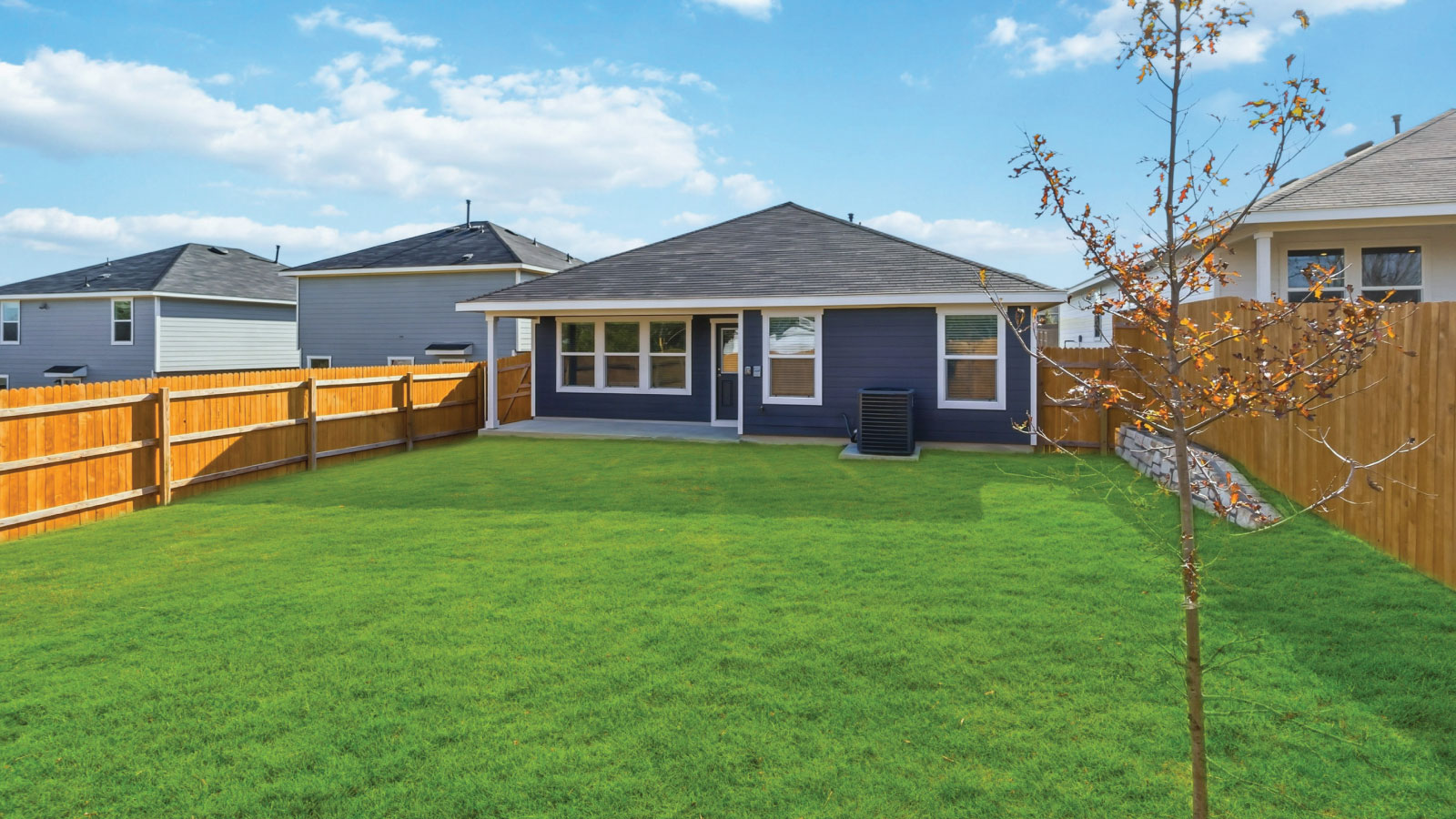 Private backyard featuring covered concrete patios with space for seating and grill setup Wayside