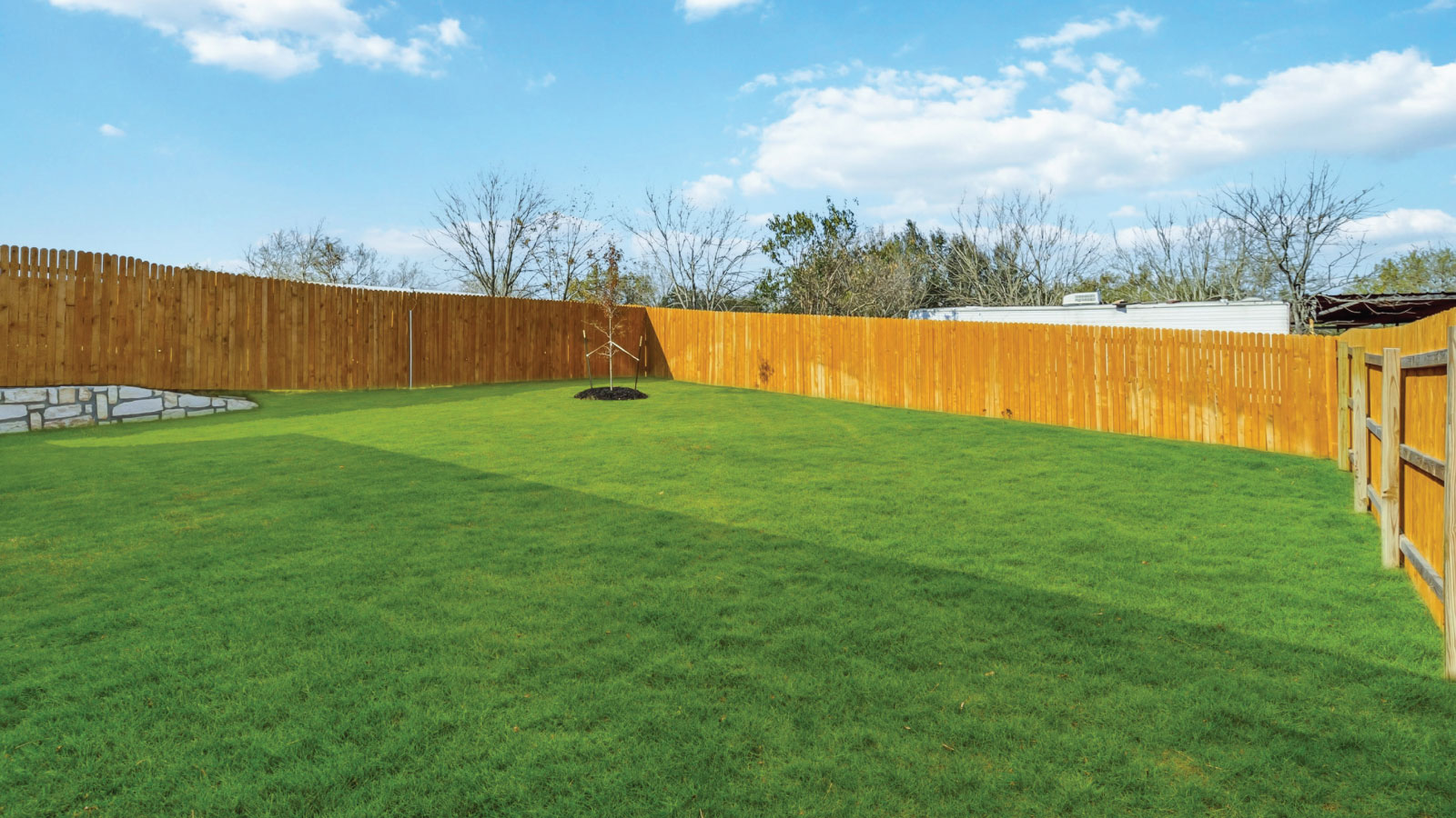 Backyard with concrete patio for grill setup, smooth indoor-outdoor transition, outdoor fun Wayside