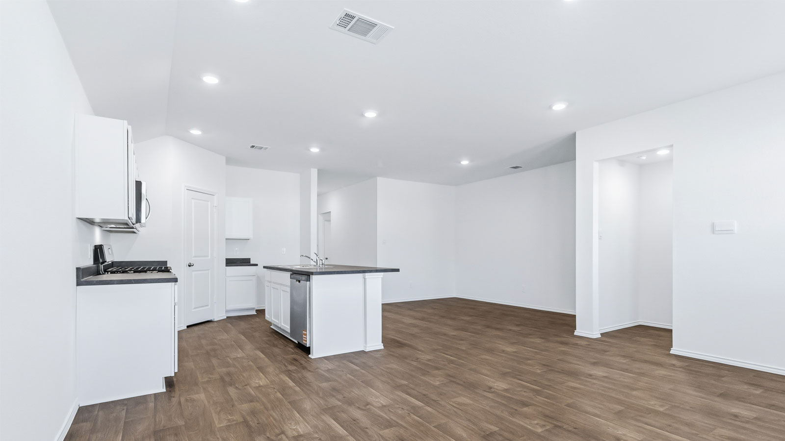 Living room with views into dining, kitchen, and upstairs to loft and bed and bath access