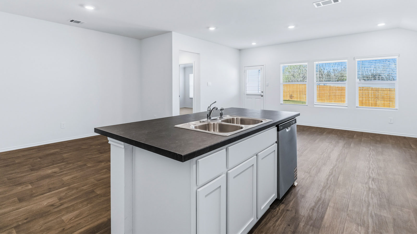 Kitchen island with sink, seating, pantry, cabinets, new appliance suite included, and multiple prep zones