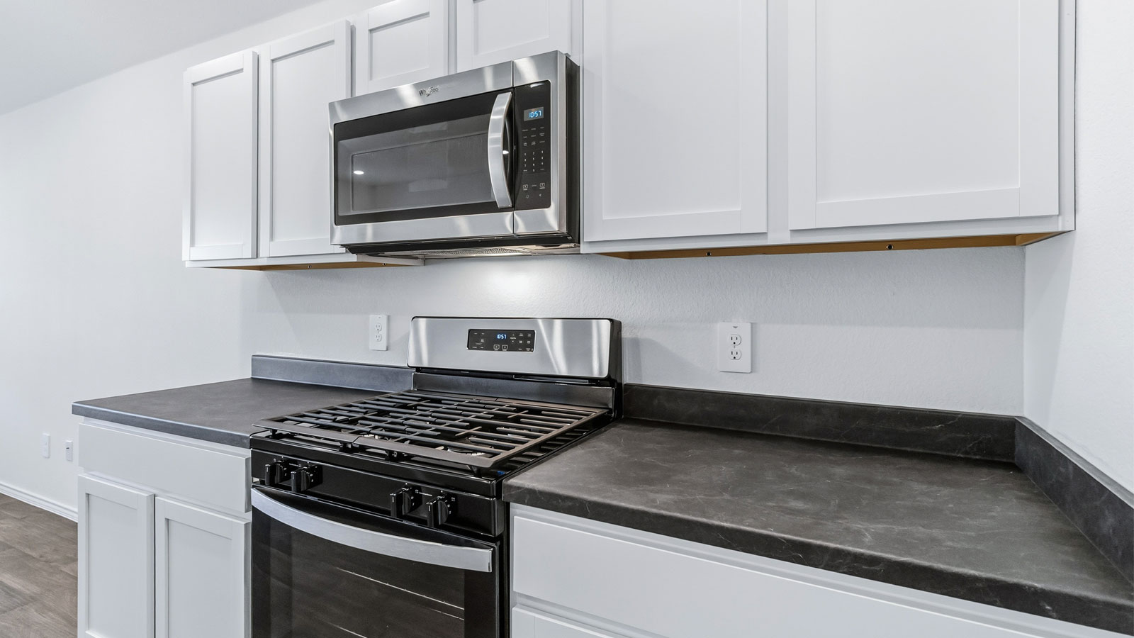 Central kitchen island designed to anchor the home with appliance suite included, sink, pantry, and multi-prep zones