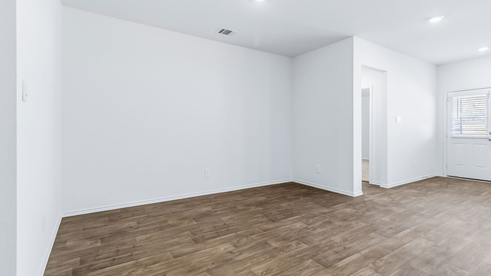 Dining room with natural light, open outdoor access and seamless flow continuing to front foyer and kitchen access