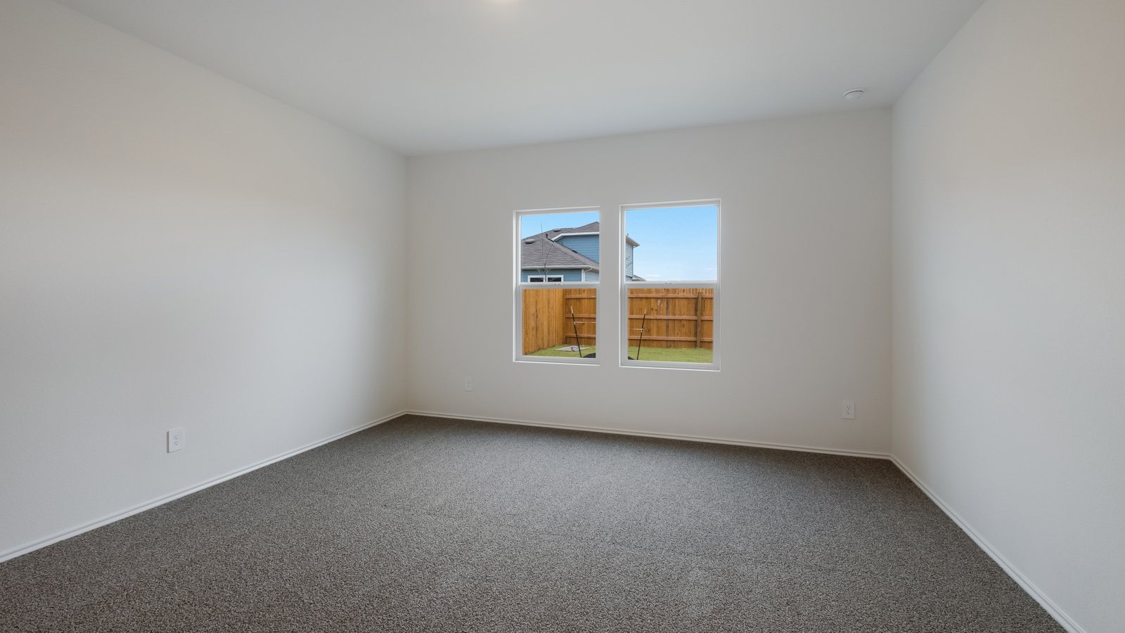 Bedroom 1 with carpeted flooring and adjoined ensuite.