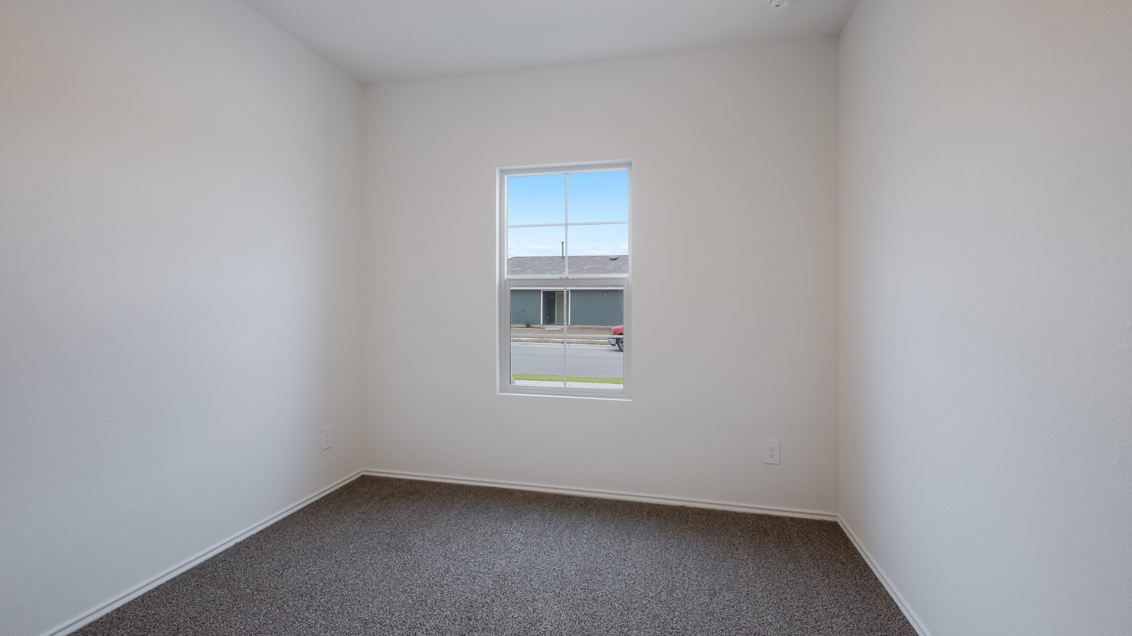Secondary bedroom with carpeted floors and closet.