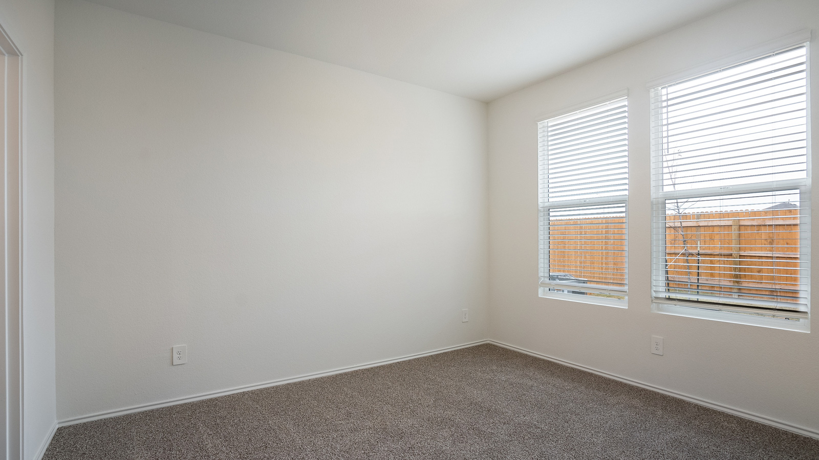 Bedroom 1 with carpeted floors.