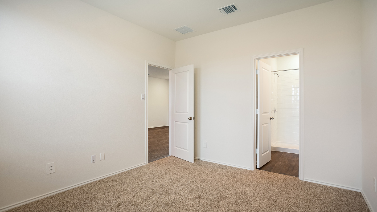 Bedroom 1 with carpeted floors.