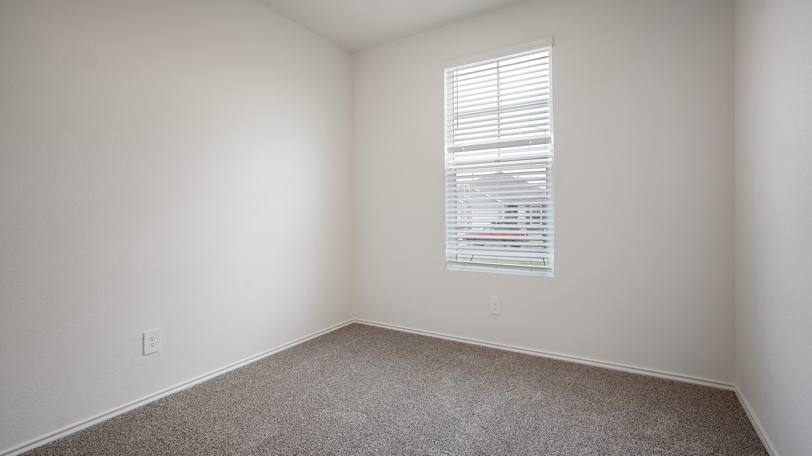 Bedroom 2 with carpeted floors.