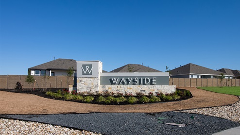 Entrance Wayside community monument surrounded by landscaping