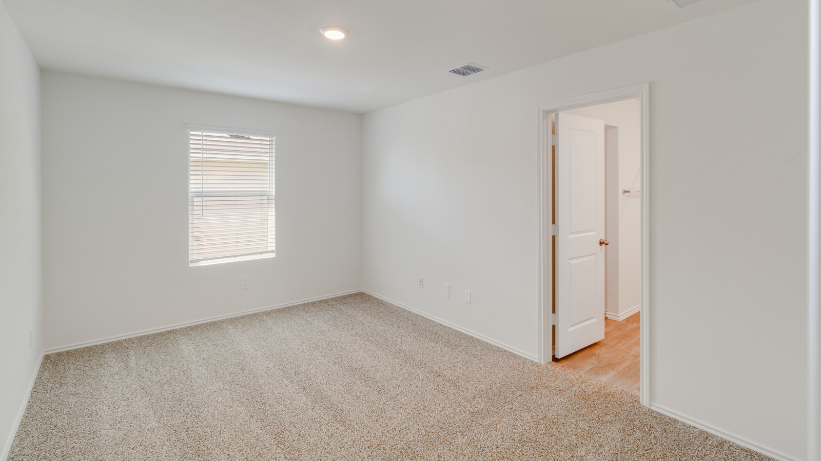 Spacious primary bedroom in New Construction Home by D.R. Horton includes Modern Design finishes and quiet rear-facing windows.