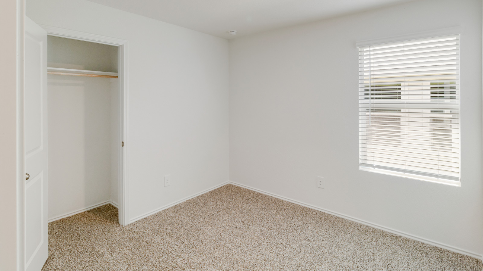 Secondary Bedroom features a traditional closet, quality carpeted floors, and a spacious room arrangement for flexible space design