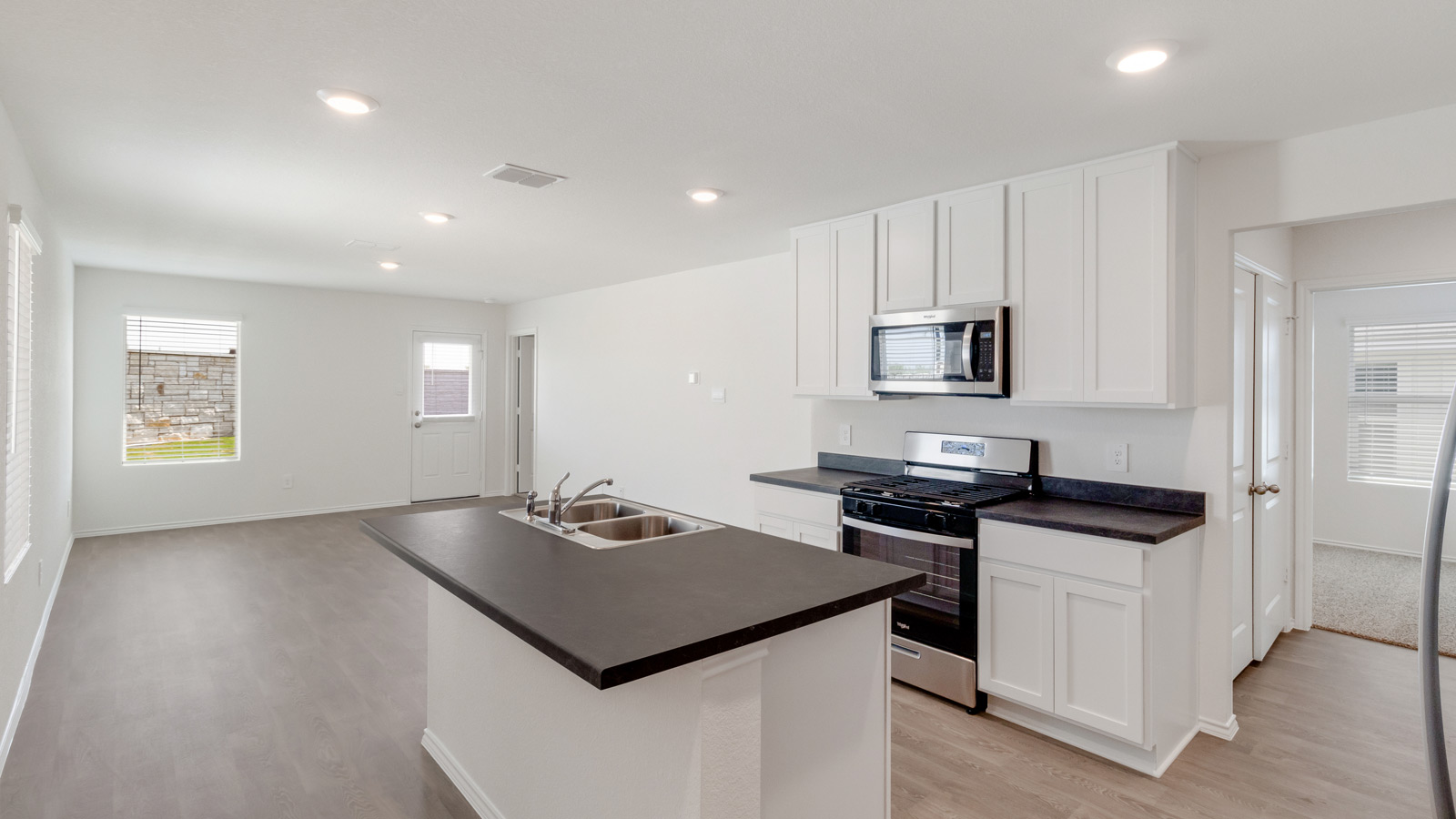 New Home kitchen island with bar seating and ample cabinet storage and pantry, sizable cooking zone