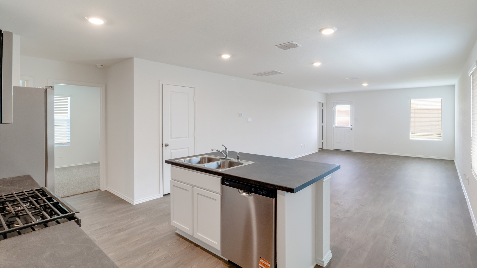 The kitchen features a large island with seating, New appliance suite, and Modern Design finishes near dining, living