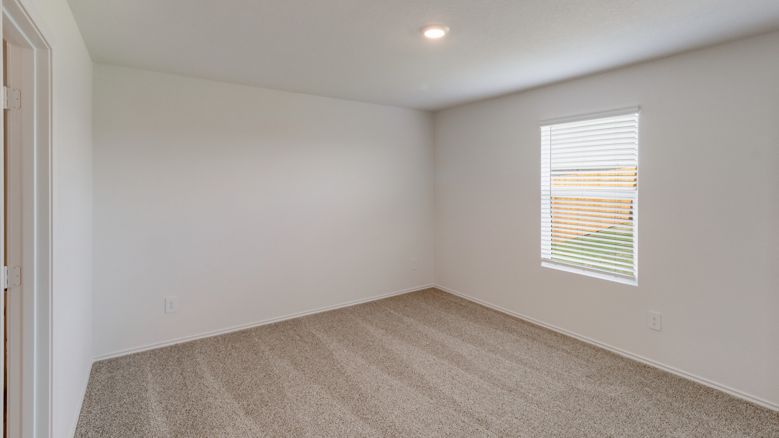 Spacious primary bedroom in New Construction Home by D.R. Horton includes Modern Design finishes and quiet rear-facing windows.
