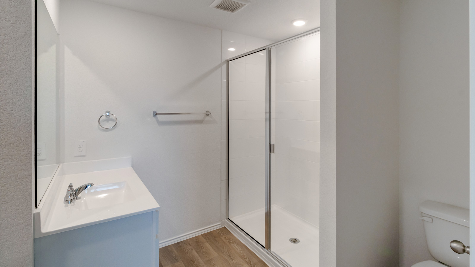 New Home showcases a D.R. Horton en suite bathroom with sleek flooring, open layout to shower-tub, and walk-in closet