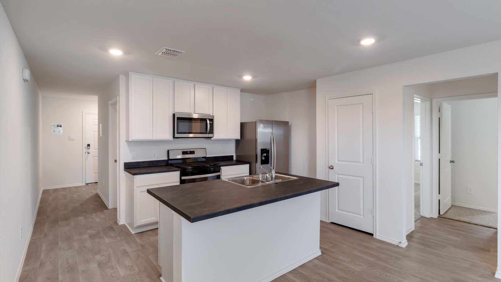 Central kitchen island crafted by D.R. Horton to anchor the space with room for meal prep, serving, and everyday gathering