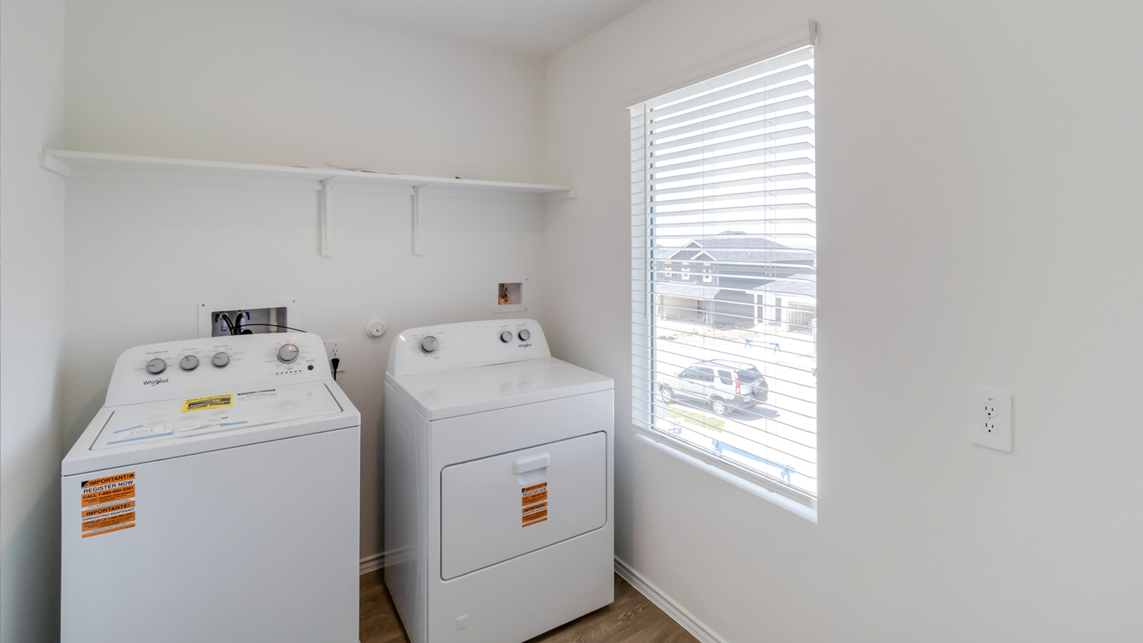 Functional D.R. Horton laundry room in Wayside featuring elevated storage for convenience