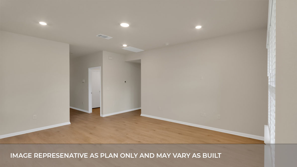 Spacious living area with laminated wood flooring.
