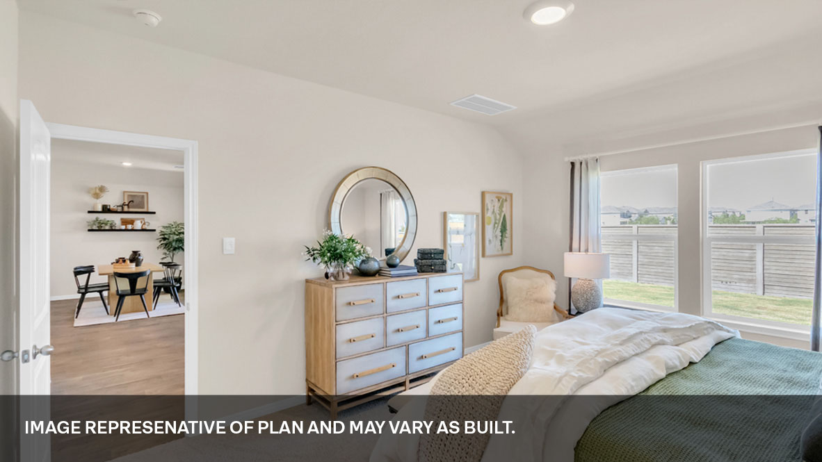 Primary bedroom with large windows.