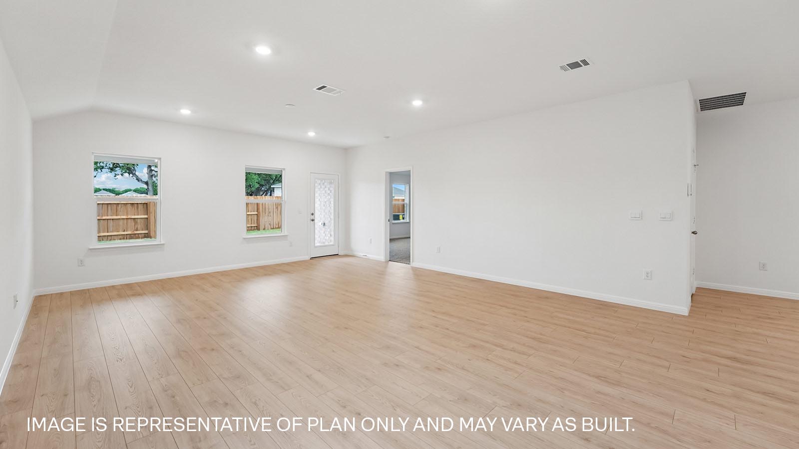 Open living area with premium wood plank laminate flooring.