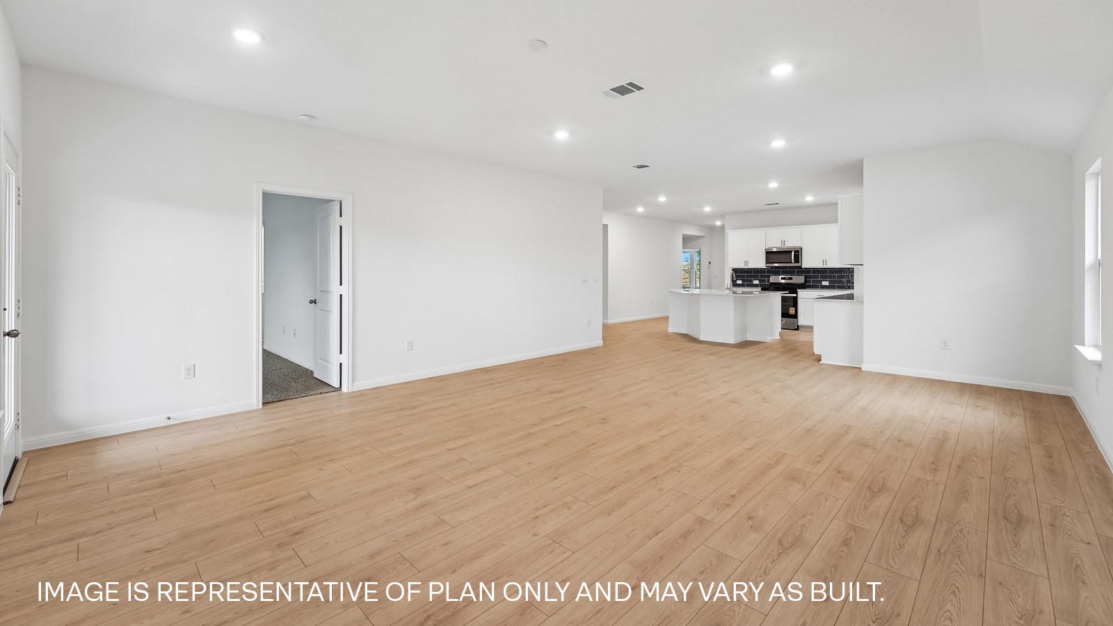 Open living area with premium wood plank laminate flooring.