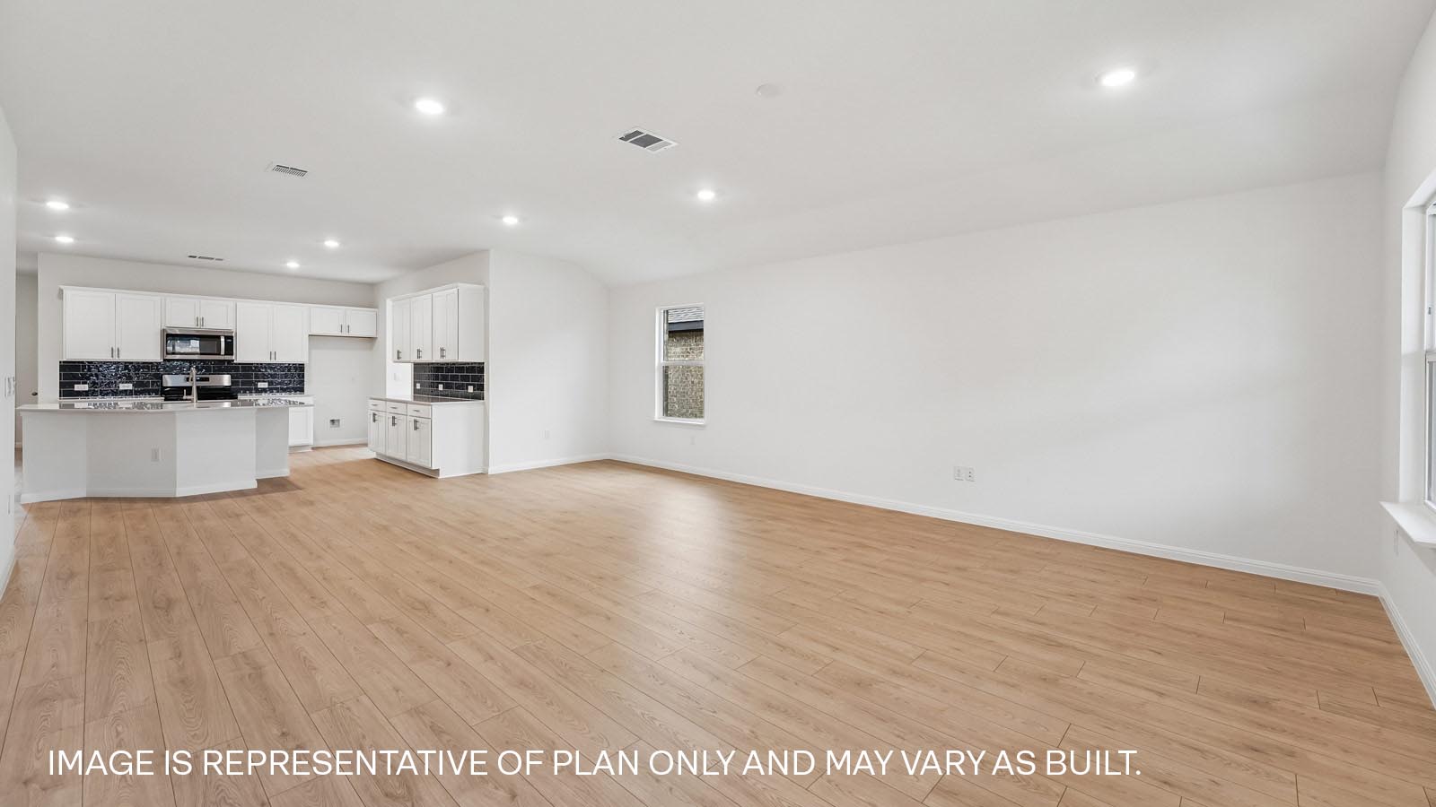 Open living area with premium wood plank laminate flooring.