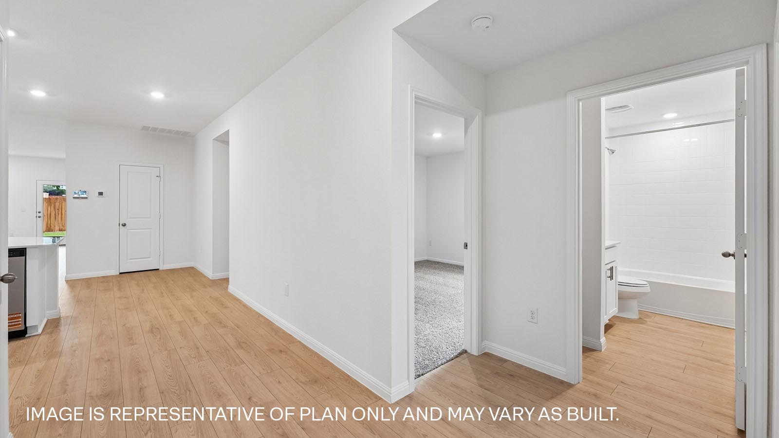 Open living area with premium wood plank laminate flooring.