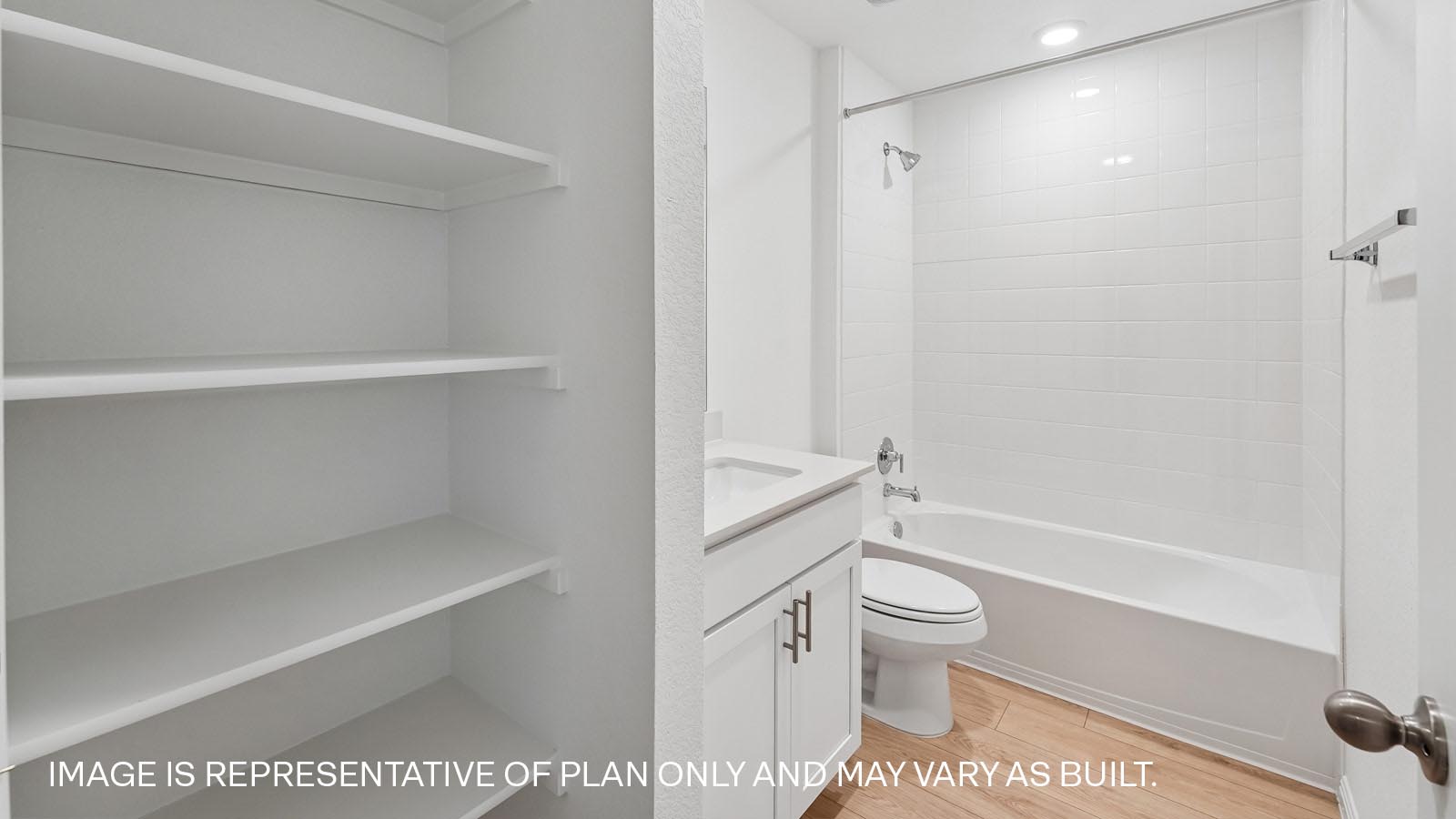 Secondary bathroom with tub and raised shower head.