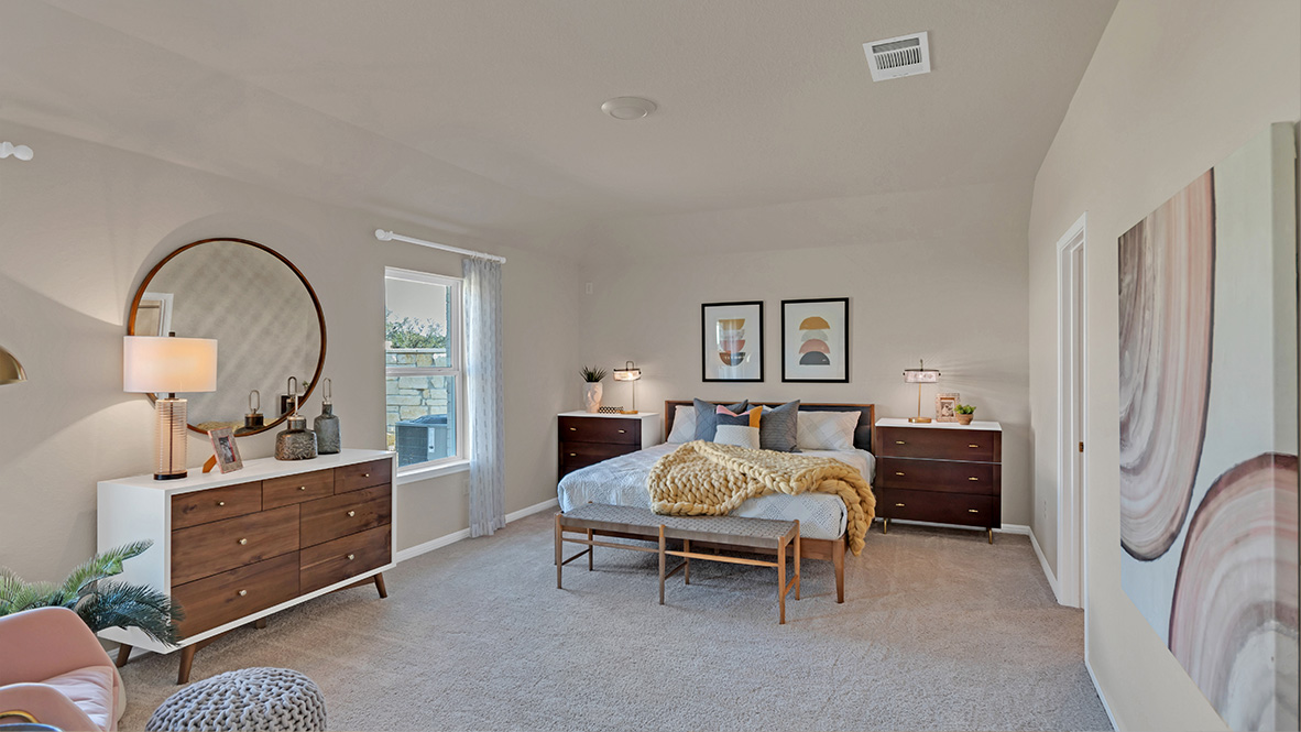 Spacious main bedroom with carpeted flooring.