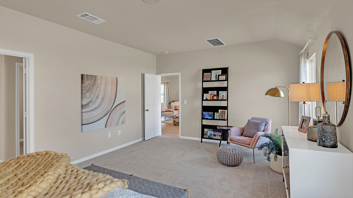 Spacious main bedroom with carpeted flooring.