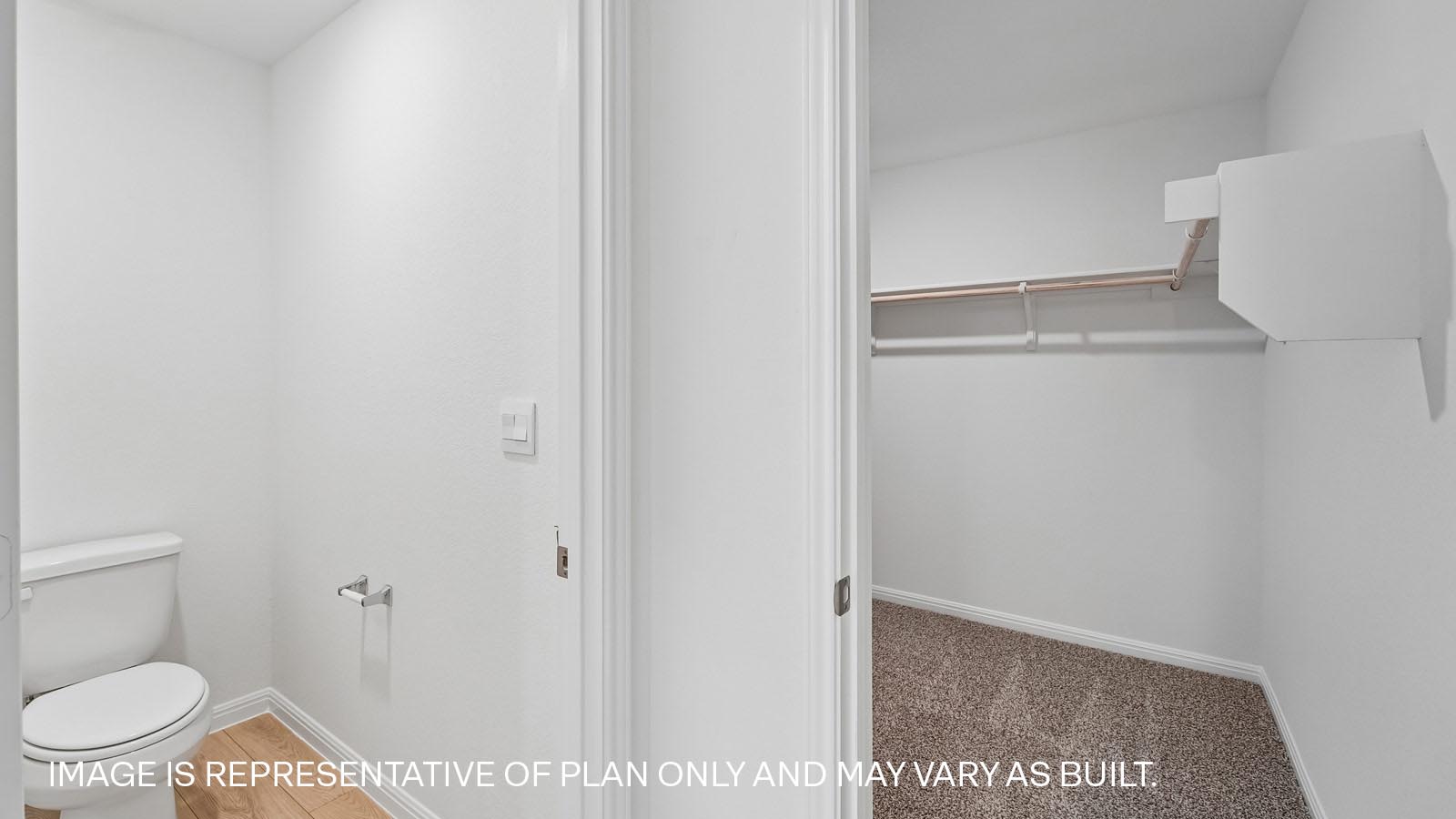 Primary bathroom with water closet and walk-in closet.