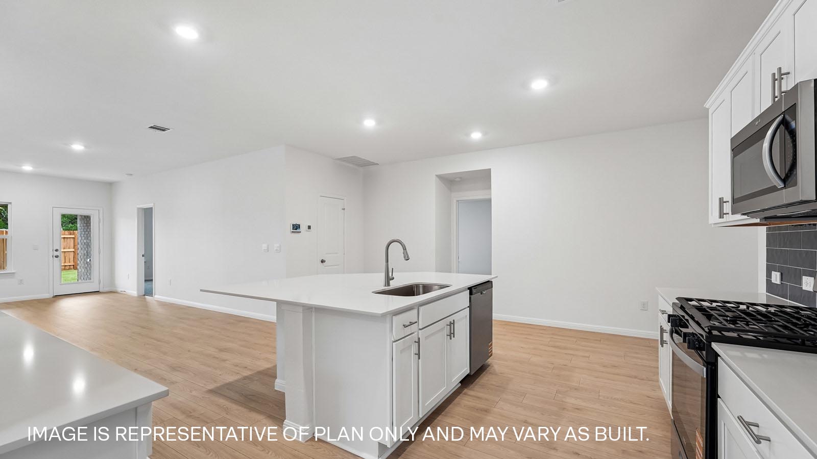 Kitchen with island and stainless steel range, microwave, and dishwasher.