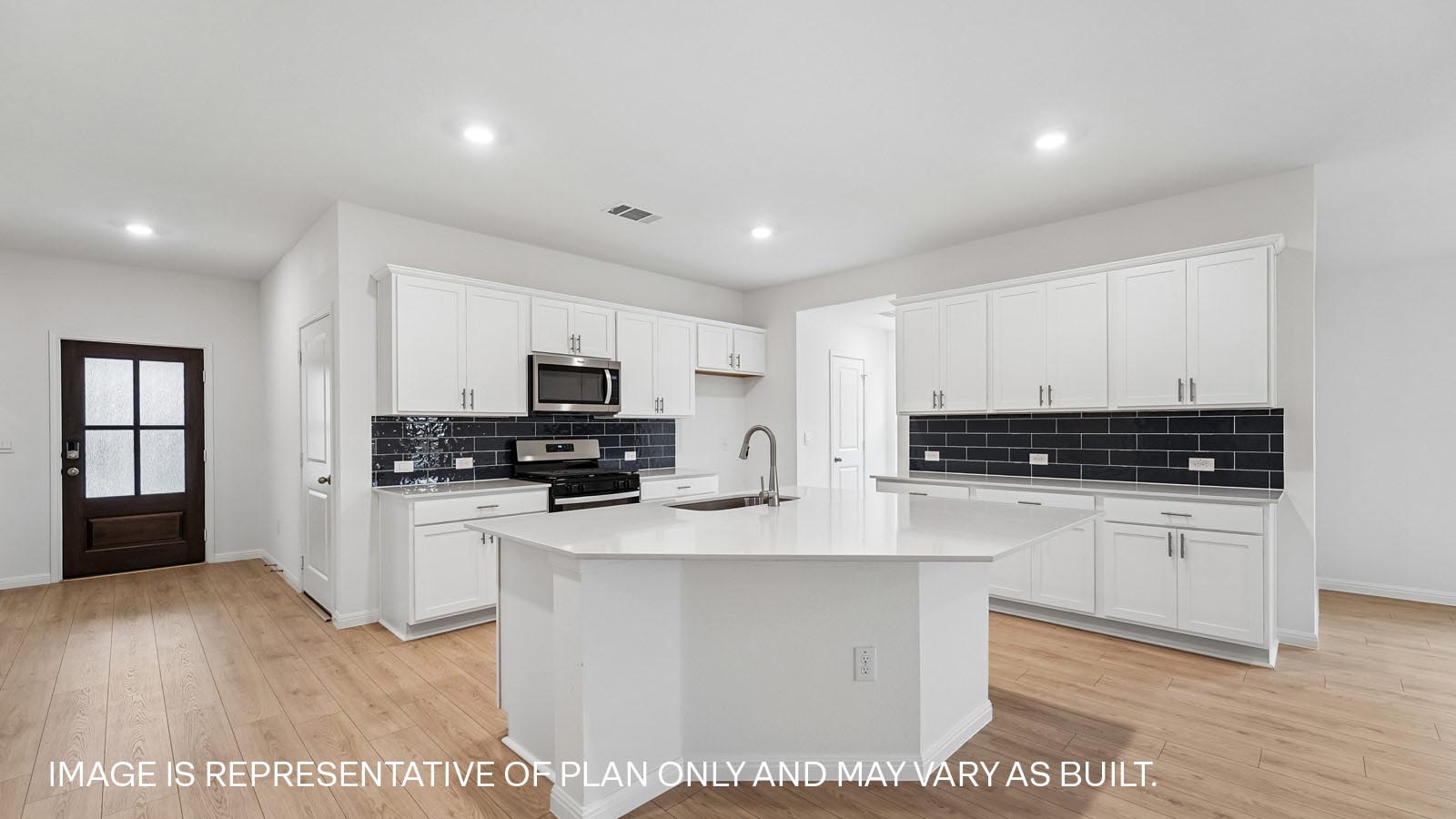 Decorative tile backsplash and quartz kitchen countertops.