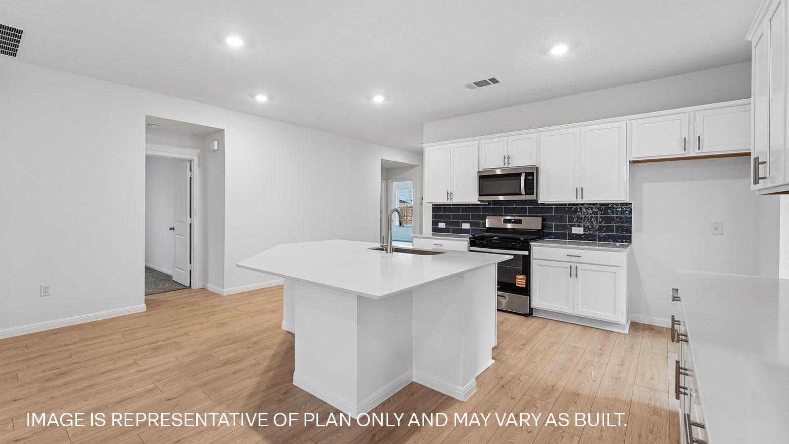 Kitchen with island and stainless steel range, microwave, and dishwasher.