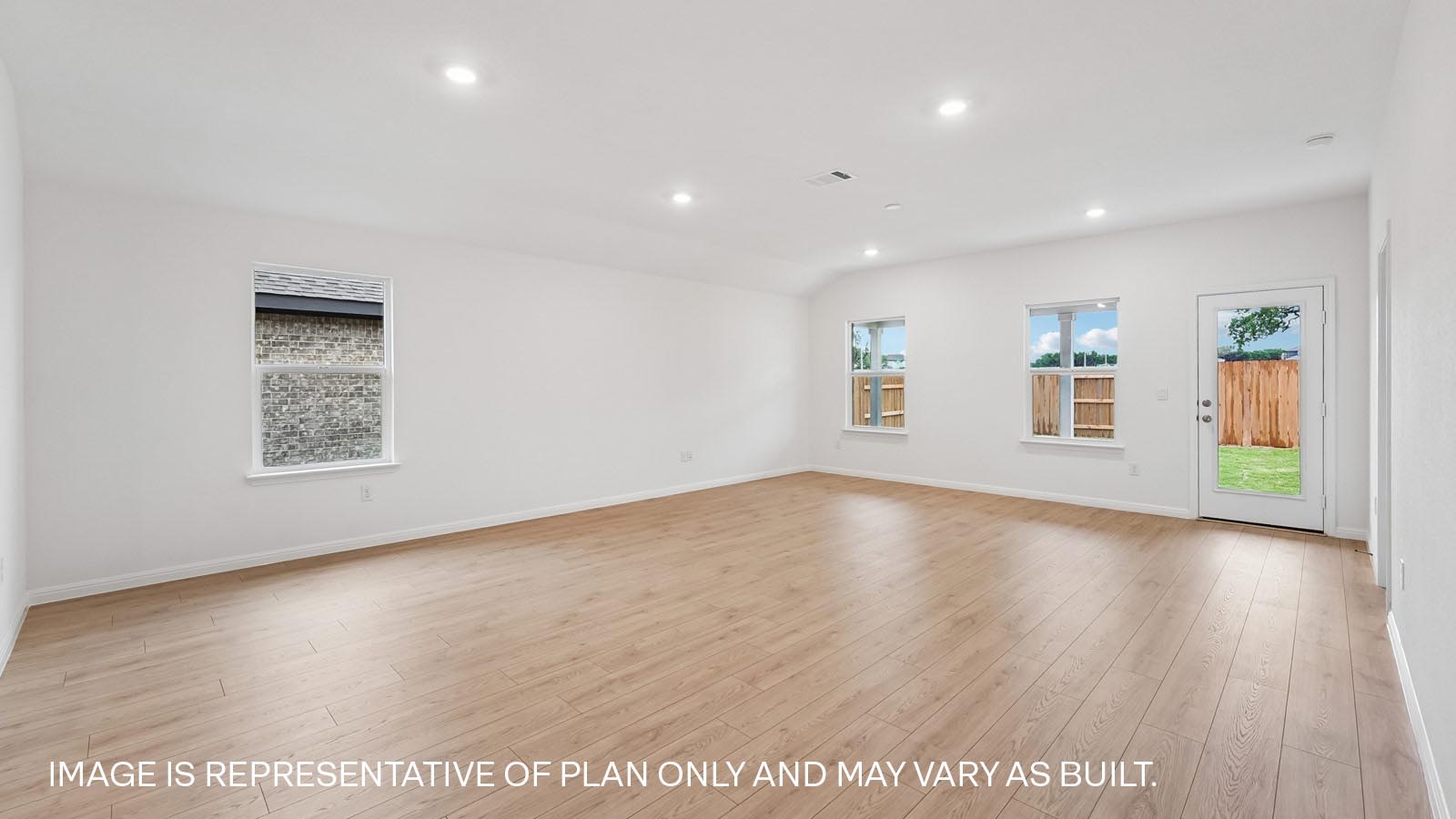 Open living area with premium wood plank laminate flooring.