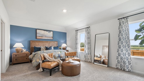 Spacious bedroom 1 with carpeted floors and large window.