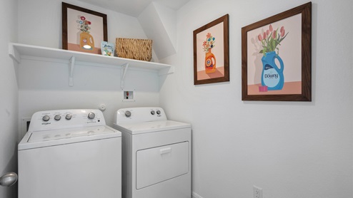 Utility room with laminated wood flooring.