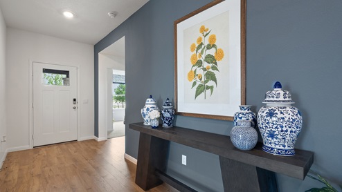 Entryway with laminated wood flooring.