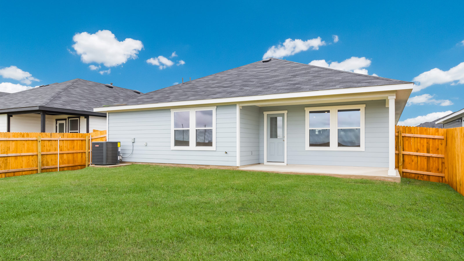 rear exterior of home featuring a spacious fenced in backyard